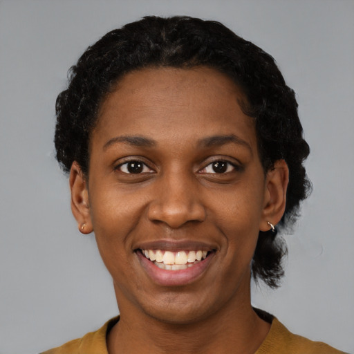 Joyful black young-adult female with short  black hair and brown eyes