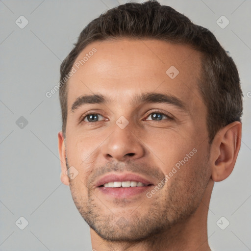 Joyful white young-adult male with short  brown hair and brown eyes