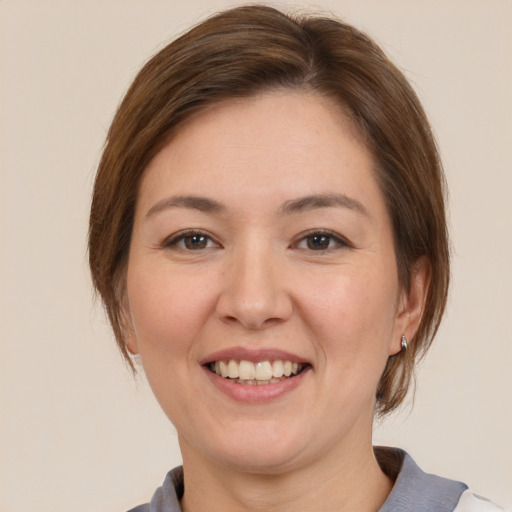 Joyful white young-adult female with medium  brown hair and brown eyes
