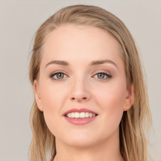 Joyful white young-adult female with medium  brown hair and grey eyes