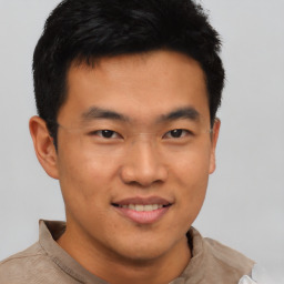 Joyful asian young-adult male with short  black hair and brown eyes