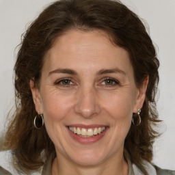 Joyful white adult female with medium  brown hair and brown eyes