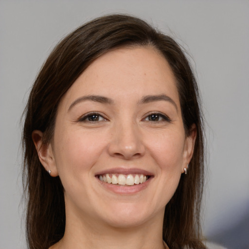 Joyful white young-adult female with medium  brown hair and brown eyes