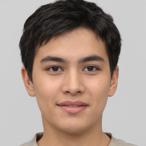 Joyful asian young-adult male with short  brown hair and brown eyes