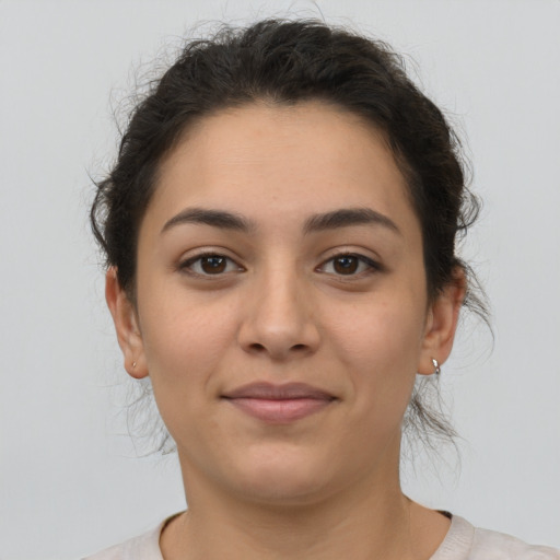 Joyful latino young-adult female with medium  brown hair and brown eyes