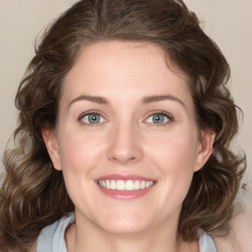 Joyful white young-adult female with medium  brown hair and green eyes