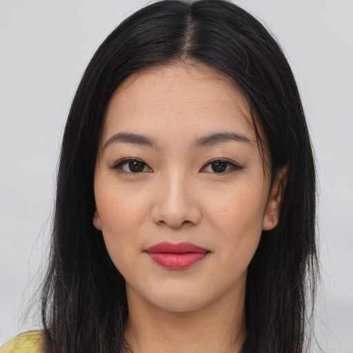 Joyful asian young-adult female with long  black hair and brown eyes