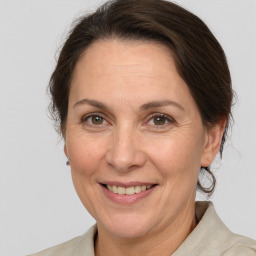 Joyful white adult female with medium  brown hair and brown eyes