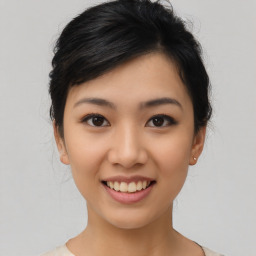 Joyful asian young-adult female with medium  black hair and brown eyes