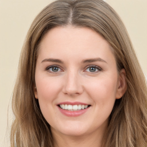 Joyful white young-adult female with long  brown hair and green eyes