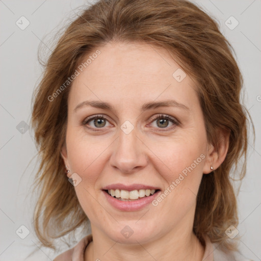 Joyful white adult female with medium  brown hair and green eyes