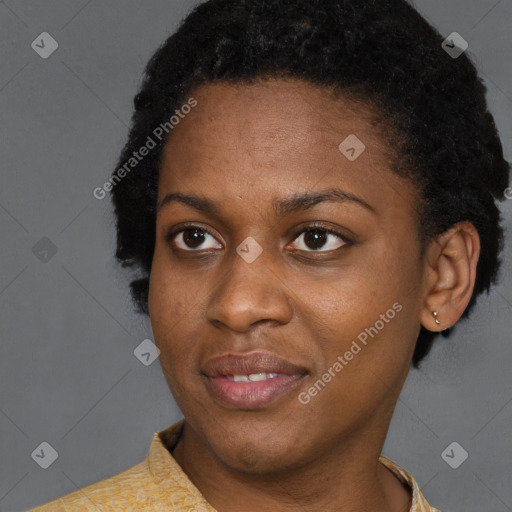 Joyful black young-adult female with short  brown hair and brown eyes