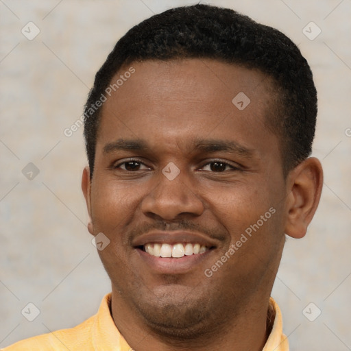 Joyful black young-adult male with short  brown hair and brown eyes