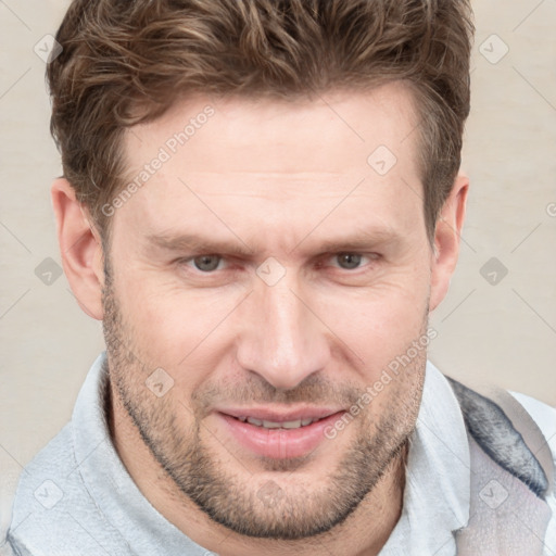 Joyful white adult male with short  brown hair and grey eyes