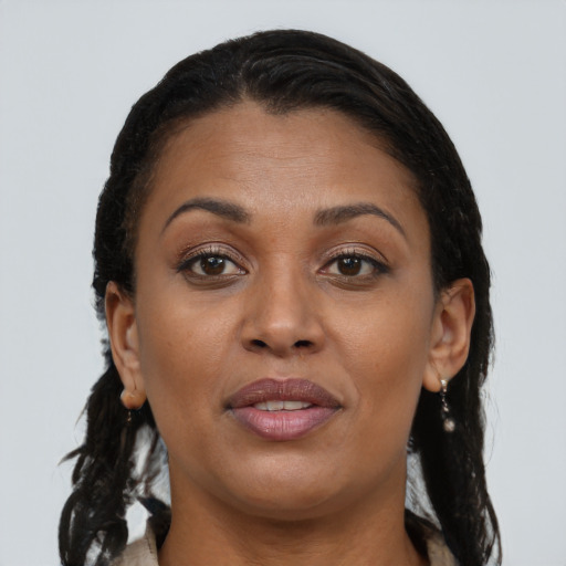 Joyful black young-adult female with long  brown hair and brown eyes