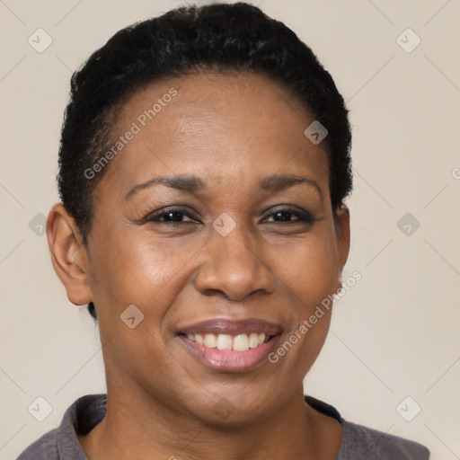 Joyful black adult female with short  black hair and brown eyes