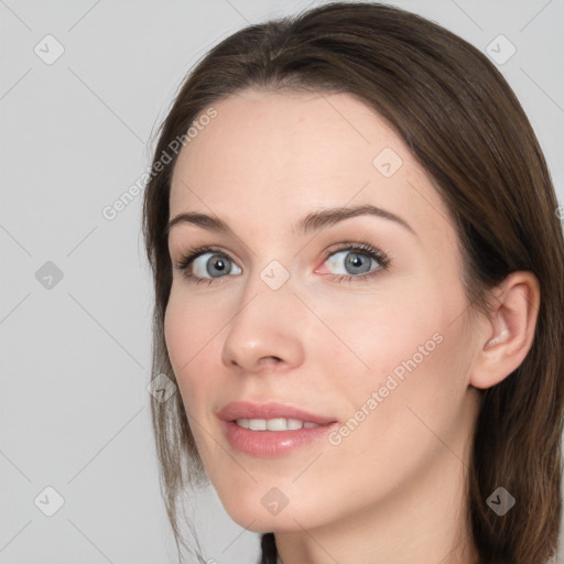 Joyful white young-adult female with long  brown hair and grey eyes