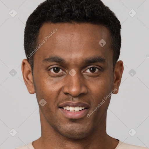 Joyful black young-adult male with short  black hair and brown eyes