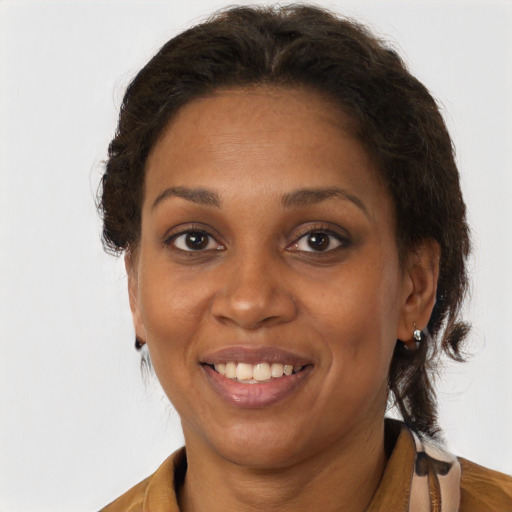 Joyful black adult female with medium  brown hair and brown eyes