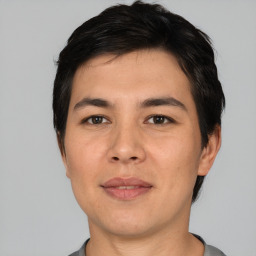 Joyful asian young-adult male with short  black hair and brown eyes