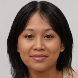 Joyful asian young-adult female with medium  brown hair and brown eyes