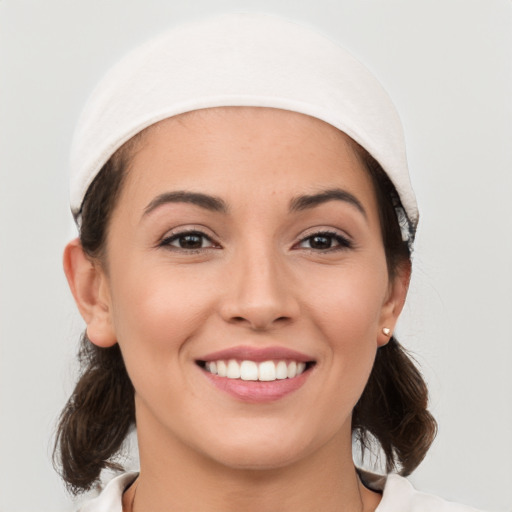 Joyful white young-adult female with medium  brown hair and brown eyes