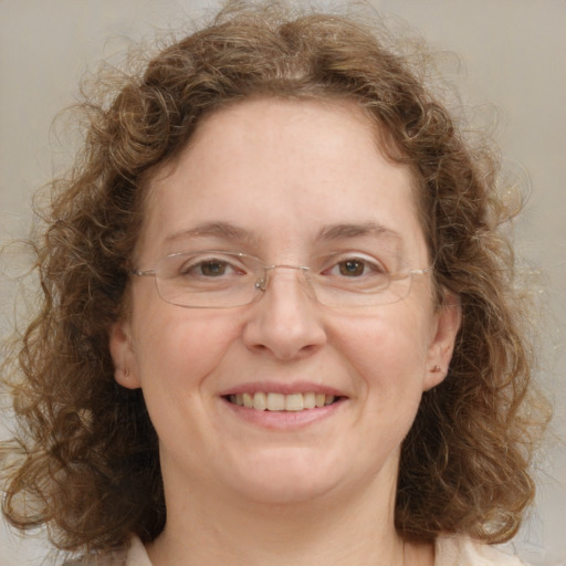 Joyful white adult female with medium  brown hair and blue eyes