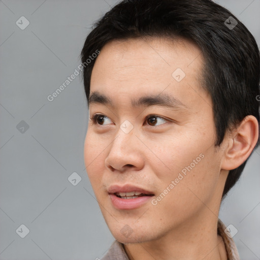 Joyful white young-adult male with short  black hair and brown eyes