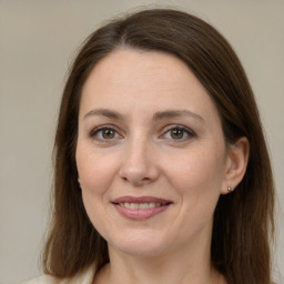 Joyful white adult female with long  brown hair and grey eyes