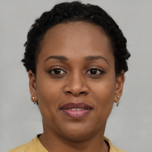 Joyful black adult female with short  brown hair and brown eyes