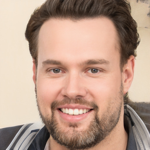 Joyful white young-adult male with short  brown hair and brown eyes