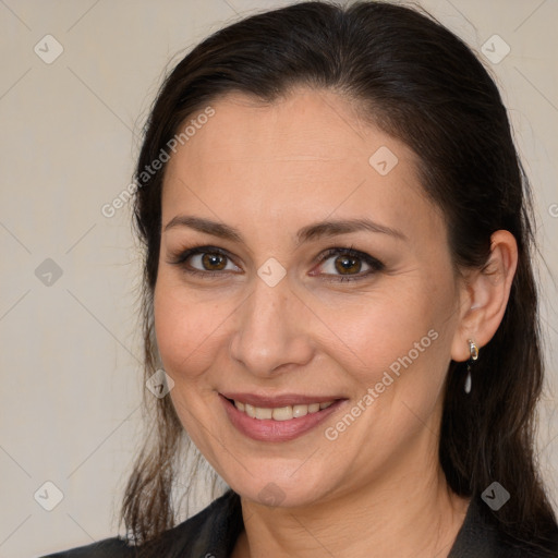 Joyful white adult female with long  brown hair and brown eyes