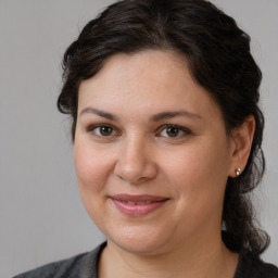 Joyful white young-adult female with medium  brown hair and brown eyes