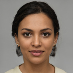 Joyful latino young-adult female with medium  brown hair and brown eyes