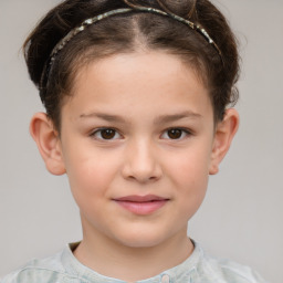 Joyful white child female with short  brown hair and brown eyes