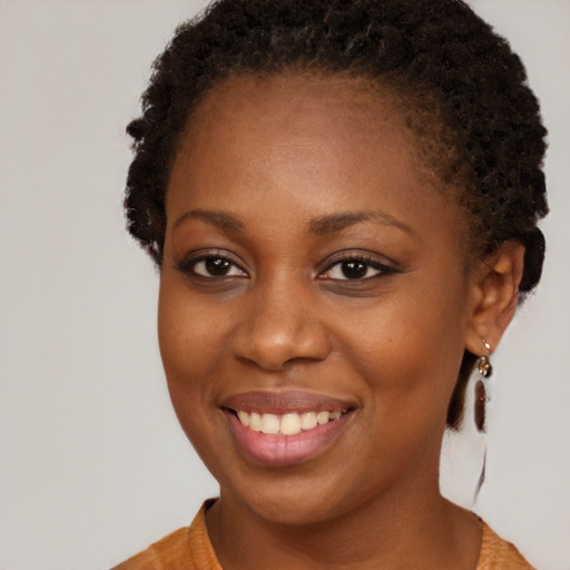 Joyful black young-adult female with medium  brown hair and brown eyes