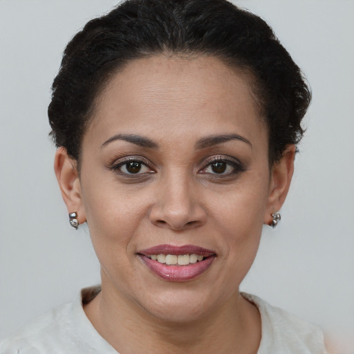 Joyful latino young-adult female with short  brown hair and brown eyes