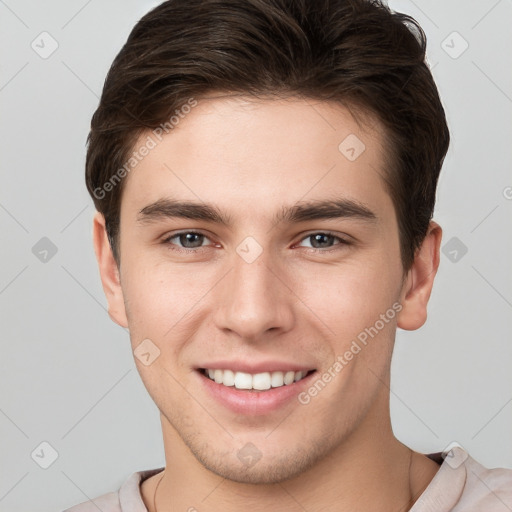 Joyful white young-adult male with short  brown hair and brown eyes