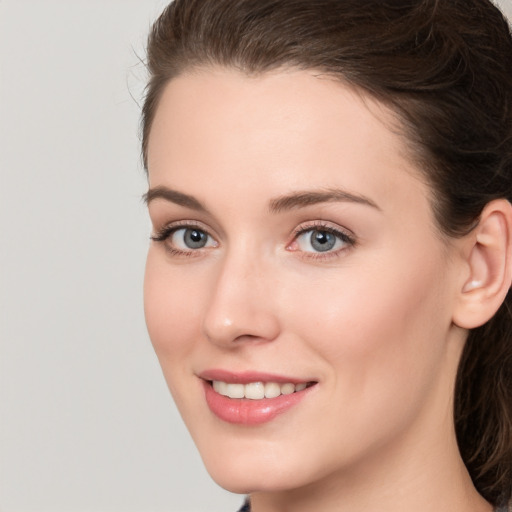 Joyful white young-adult female with long  brown hair and grey eyes