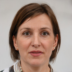 Joyful white adult female with medium  brown hair and grey eyes