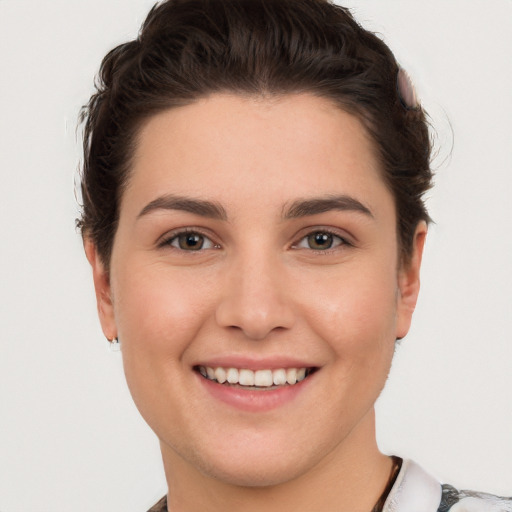 Joyful white young-adult female with short  brown hair and brown eyes