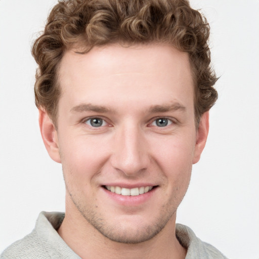 Joyful white young-adult male with short  brown hair and blue eyes