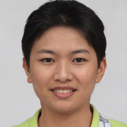 Joyful asian young-adult female with short  brown hair and brown eyes