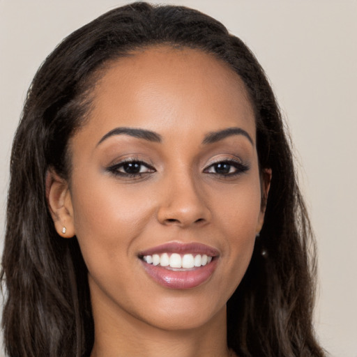 Joyful latino young-adult female with long  brown hair and brown eyes