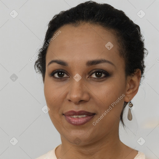 Joyful black young-adult female with short  brown hair and brown eyes