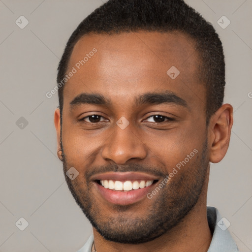 Joyful black young-adult male with short  brown hair and brown eyes