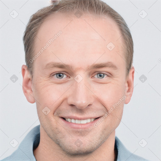 Joyful white adult male with short  brown hair and grey eyes