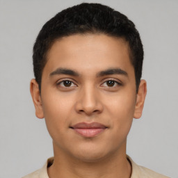 Joyful latino young-adult male with short  brown hair and brown eyes