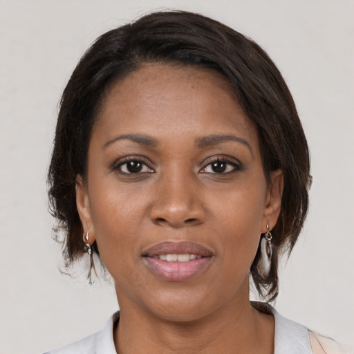 Joyful black young-adult female with medium  brown hair and brown eyes