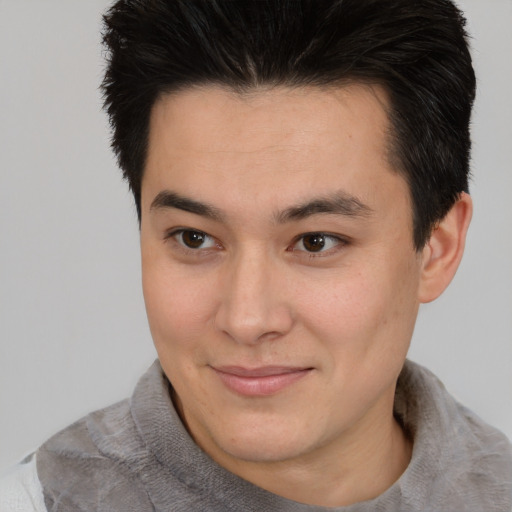 Joyful asian young-adult male with short  brown hair and brown eyes